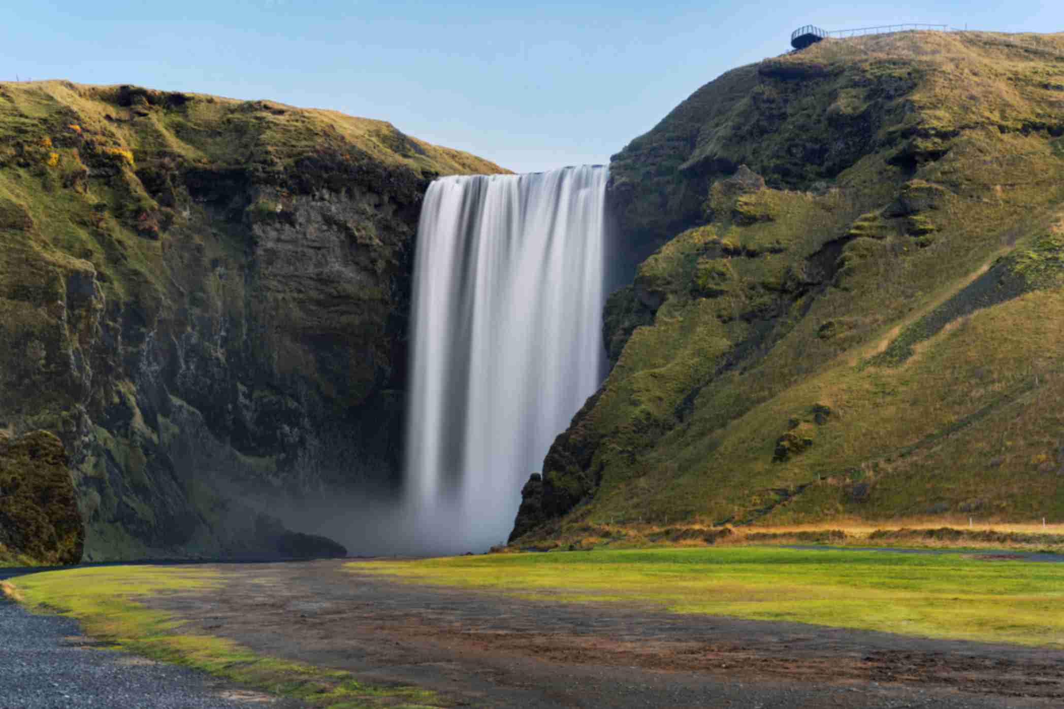 Skógafoss waterfall with mist and rainbow on Iceland’s South Coast
