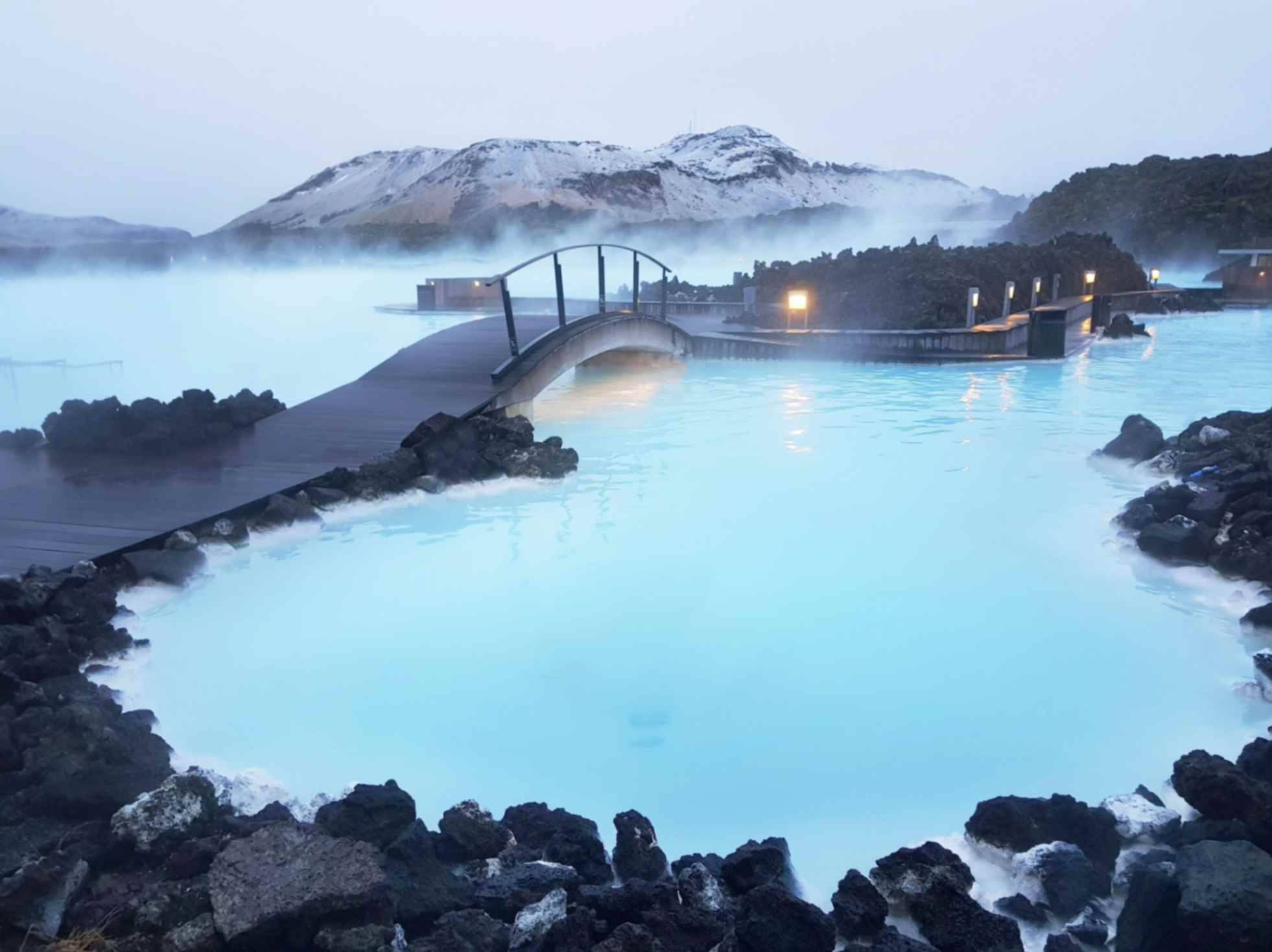 Blue Lagoon geothermal spa with milky blue water and lava rocks in Iceland