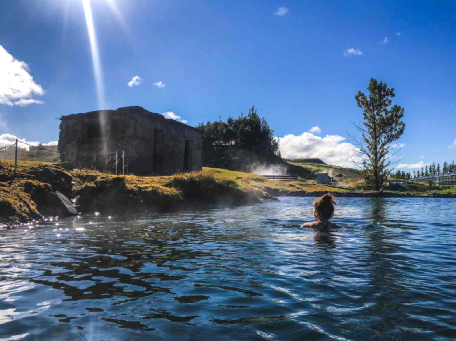 Secret Lagoon geothermal pool with swimmer in Flúðir near Iceland’s Golden Circle Secret Lagoon geothermal pool with swimmer in Flúðir near Iceland’s Golden Circle