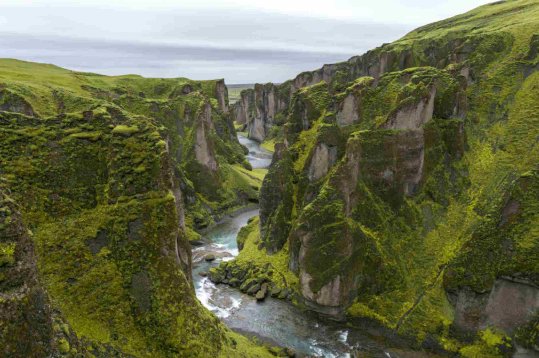 Fjaðrárgljúfur canyon with winding river and green cliffs