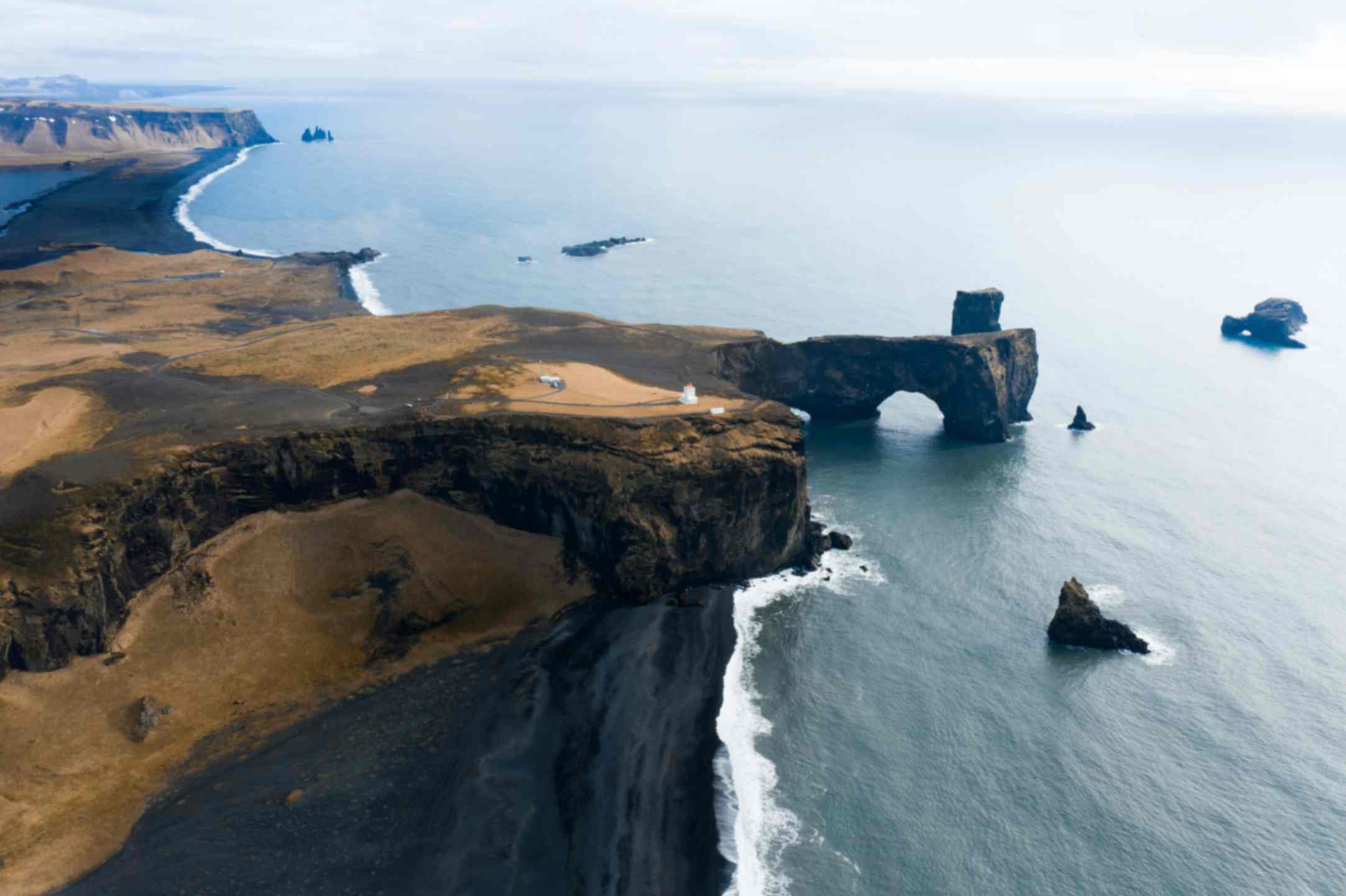 Dyrhólaey cliffs and sea arch on Iceland's South Coast, a popular puffin nesting location Dyrhólaey cliffs and sea arch on Iceland's South Coast, a popular puffin nesting location